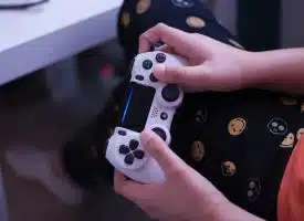 person holding white sony ps 4 controller